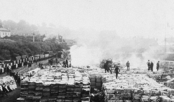 Men on stacks of paper.