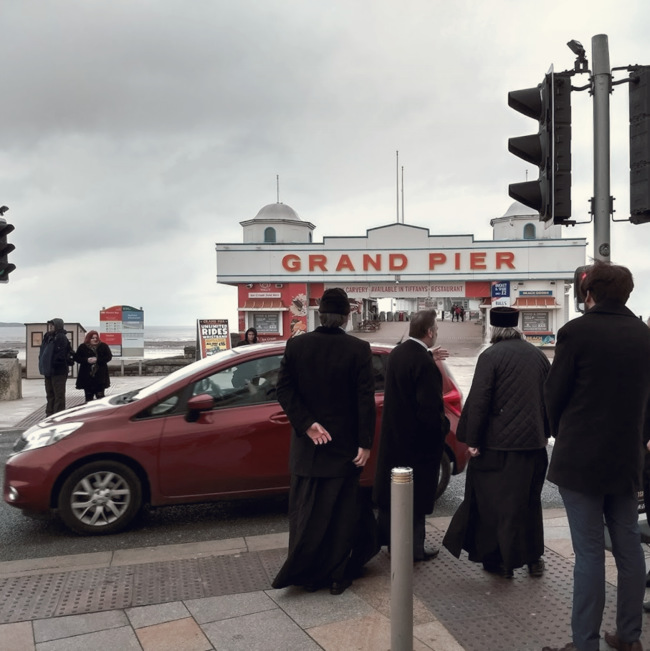 Priests near a pier.