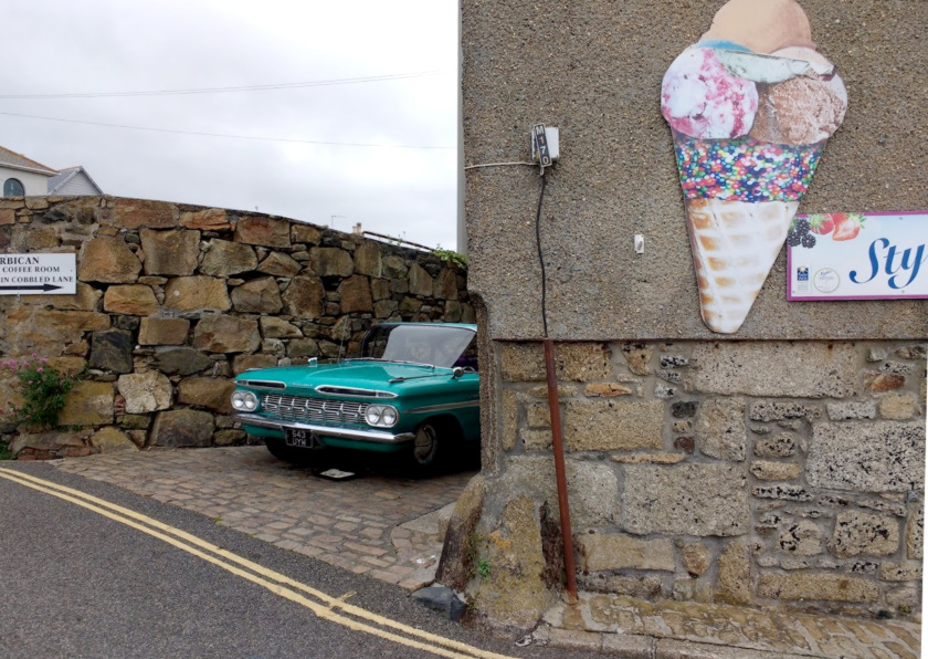 A vintage car behind an ice cream parlour in Penzance.