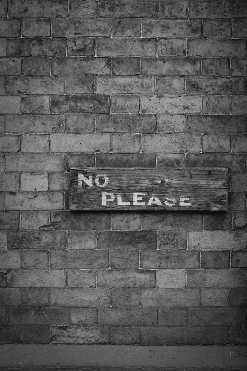 Eroded sign: PLEASE NO....