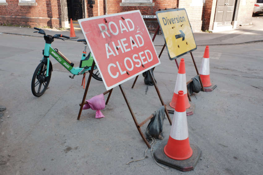 Temporary signs that read "Road ahead closed" and "Diversion".