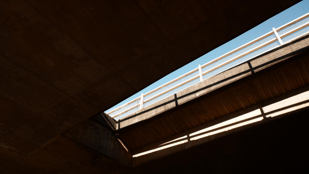 A sliver of blue sky visible between the concrete decks of the M32 flyover at Eastville, Bristol.