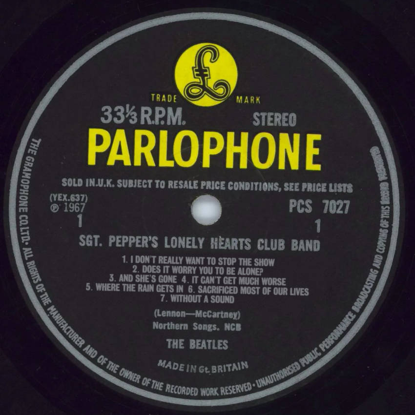 The label of Sgt. Pepper except the songs are called: 1. I DON’T REALLY WANT TO STOP THE SHOW
2. DOES IT WORRY YOU TO BE ALONE?
3. AND SHE’S GONE  4. IT CAN’T GET MUCH WORSE
5. WHERE THE RAIN GETS IN  6. SACRIFICED MOST OF OUR LIVES
7. WITHOUT A SOUND