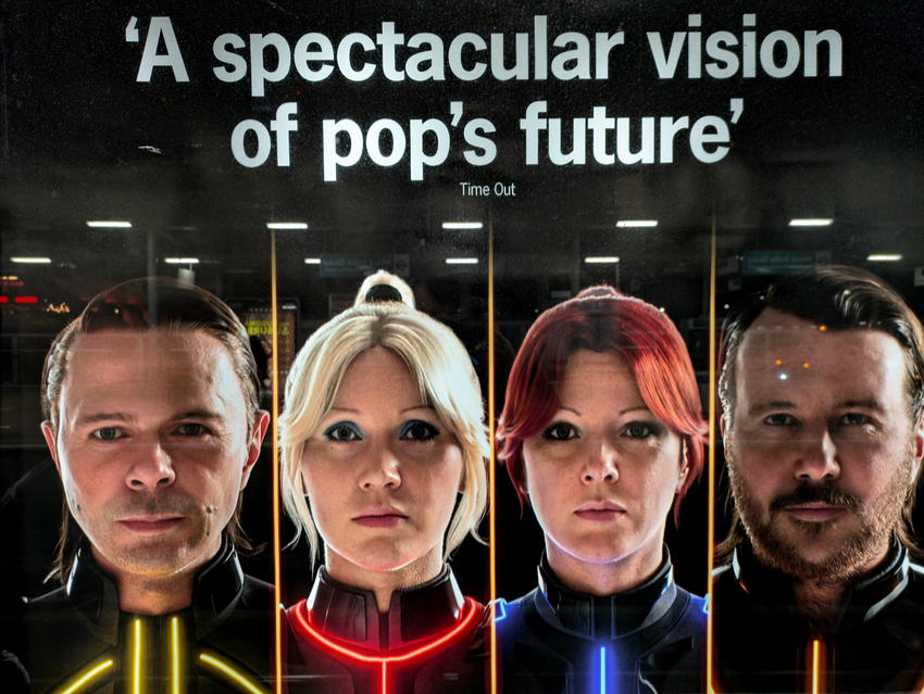 An advert on the London Underground for ABBA Voyage with the faces of the digital simulations of the members of the band and a quote from Time Out: "A spectacular vision of pop's future."