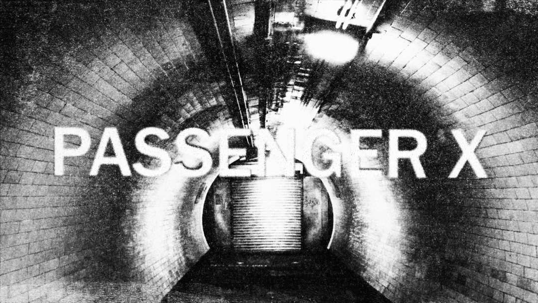 A grainy image of a dead end tunnel in a London Underground station. The text Passenger X is overlaid.